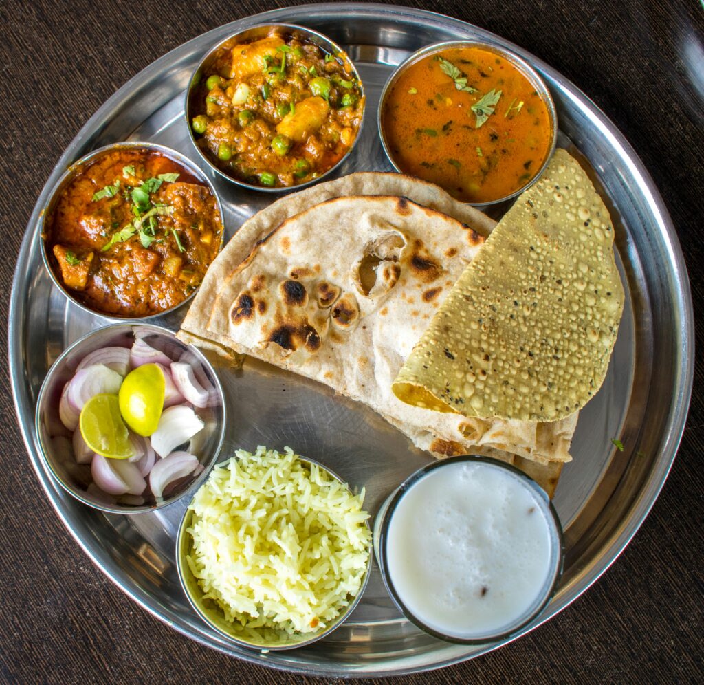 Enjoy a delicious Indian thali showcasing traditional cuisine with various dishes.